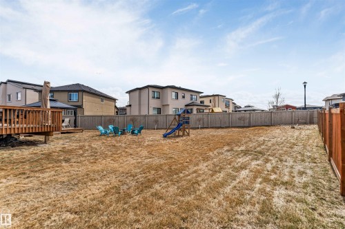 Spacious backyard featuring a full privacy fence, wood deck, and a separate patio area with a gazebo - 1923 19 Avenue, Edmonton, AB - Outdoor