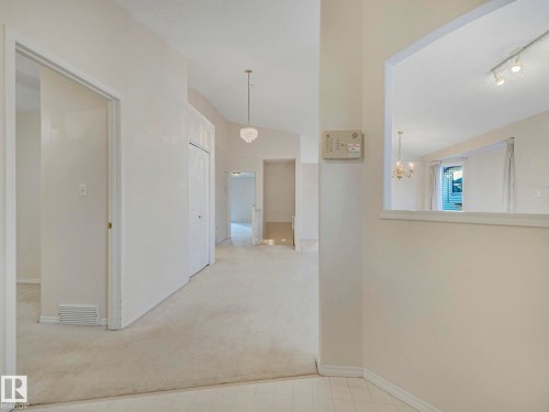 Open concept interior featuring light-toned carpeting and neutral wall colors - 23 9731 174 Street, Edmonton, AB - Indoor Photo Showing Other Room
