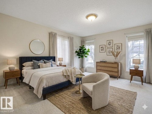 Spacious bedroom featuring plush carpeting, dual windows with white blinds and drapes, and a ceiling-mounted light fixture - 23 9731 174 Street, Edmonton, AB - Indoor Photo Showing Bedroom