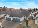 Ranch-style dwelling with a two-car garage, gray shingle roof, and light-toned siding - 23 9731 174 Street, Edmonton, AB  - Outdoor 
