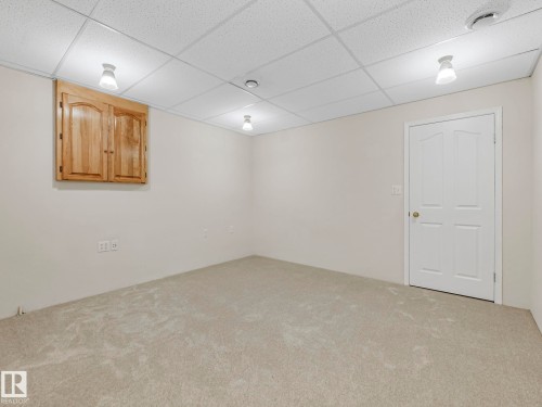Neutral-toned wall-to-wall carpeting and off-white walls - 23 9731 174 Street, Edmonton, AB - Indoor Photo Showing Other Room