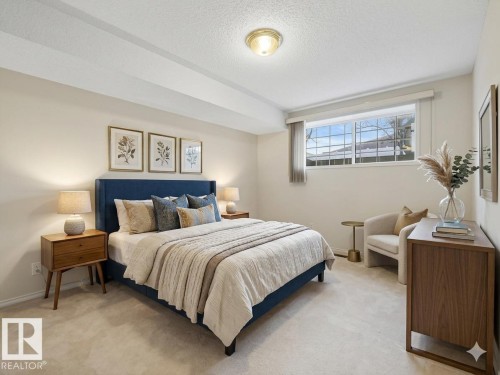 Carpeted room with a wide window, recessed ceiling detail, and a flush mount ceiling light - 23 9731 174 Street, Edmonton, AB - Indoor Photo Showing Bedroom