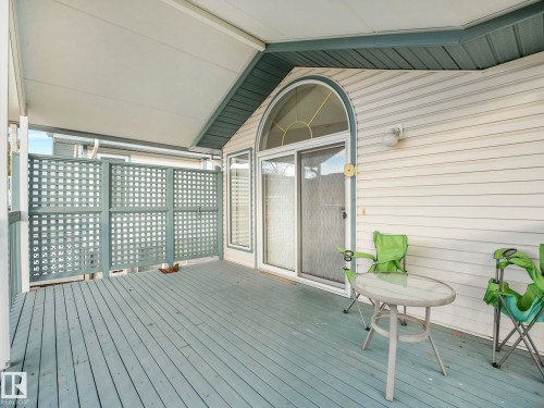 Covered outdoor deck featuring wood-finish flooring - 23 9731 174 Street, Edmonton, AB - Outdoor With Deck Patio Veranda With Exterior