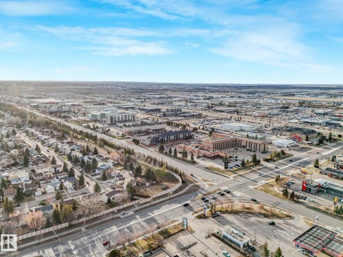 Aerial perspective showcasing a mixed-use neighborhood with residential zones and commercial developments - 23 9731 174 Street, Edmonton, AB - Outdoor With View