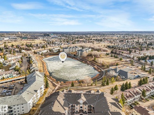 Aerial perspective showcasing a residential area with a prominent frozen body of water - 23 9731 174 Street, Edmonton, AB - Outdoor With View