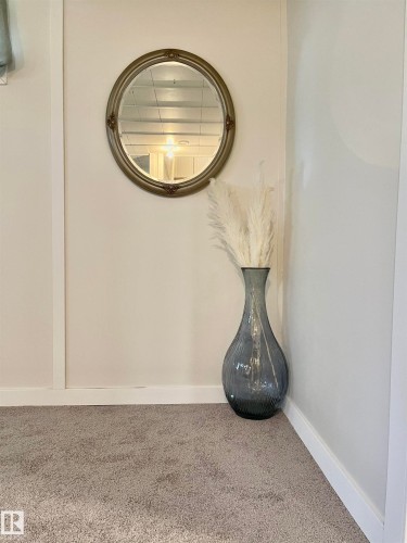 Neutral-toned walls accented by white trim and light gray carpeting - 11681 72 Avenue, Edmonton, AB - Indoor Photo Showing Other Room