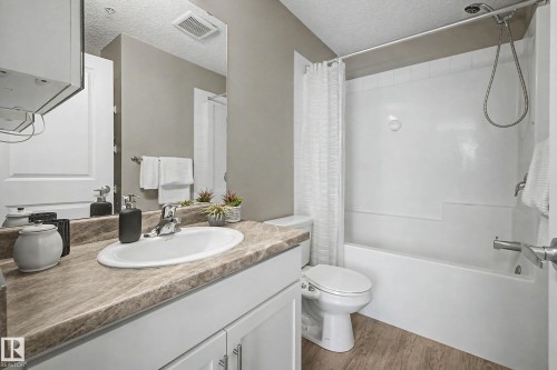 Bathroom featuring a white bathtub/shower combination with a hand-held shower fixture - 217 394 Windermere Road, Edmonton, AB - Indoor Photo Showing Bathroom