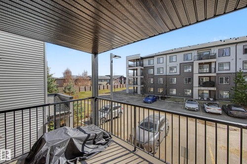 Private balcony with dark gray composite decking and a black metal railing - 217 394 Windermere Road, Edmonton, AB - Outdoor With Balcony
