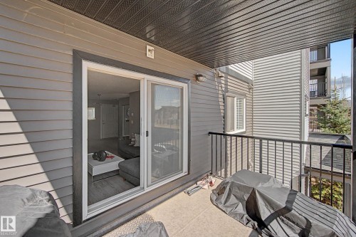 Covered balcony featuring a concrete surface and black metal railing - 217 394 Windermere Road, Edmonton, AB - Outdoor With Exterior