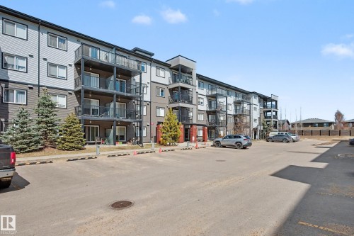 Contemporary multi-story building featuring a gray and dark gray facade with multiple private balconies - 217 394 Windermere Road, Edmonton, AB - Outdoor With Balcony