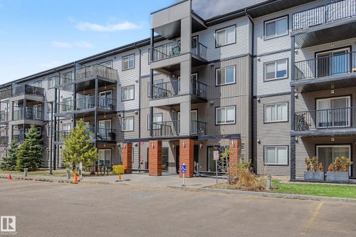 Contemporary multi-story building featuring a facade with mixed siding materials - 217 394 Windermere Road, Edmonton, AB - Outdoor With Balcony