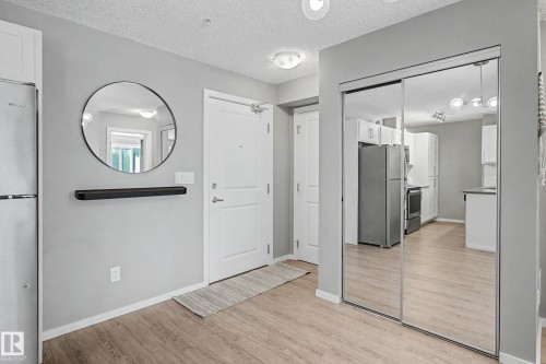 Entryway featuring wood-finish flooring, light grey walls, and a recessed ceiling light fixture - 217 394 Windermere Road, Edmonton, AB - Indoor Photo Showing Other Room