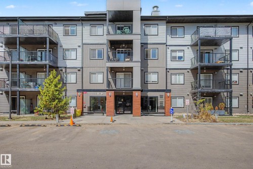 Multi-story residential building featuring a contemporary facade with varying shades of gray siding - 217 394 Windermere Road, Edmonton, AB - Outdoor With Balcony With Facade
