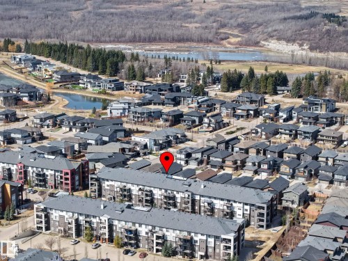 Aerial perspective showcasing a residential community with multi-story buildings and single-family homes - 217 394 Windermere Road, Edmonton, AB - Outdoor With View