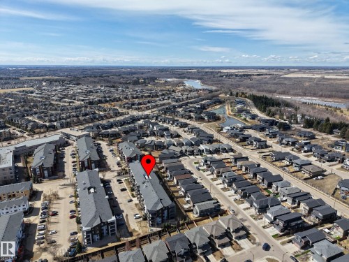 Aerial perspective of a developed residential area featuring a mix of multi-story apartment buildings and single-family homes - 217 394 Windermere Road, Edmonton, AB - Outdoor With View