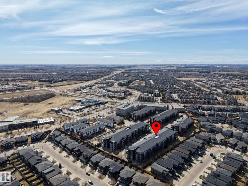 Aerial perspective showcasing a residential area with a mix of multi-story apartment buildings and single-family homes - 217 394 Windermere Road, Edmonton, AB - Outdoor With View