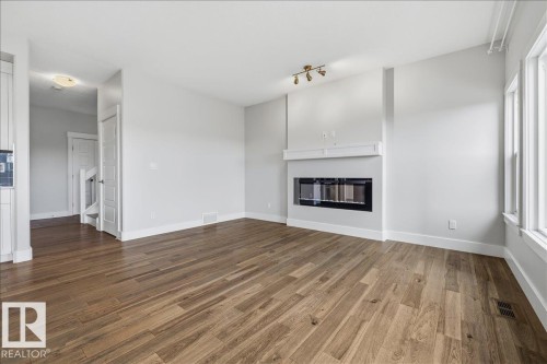 88 Tribute Common, Spruce Grove, AB - Indoor Photo Showing Living Room With Fireplace