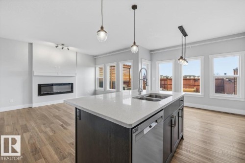 88 Tribute Common, Spruce Grove, AB - Indoor Photo Showing Kitchen With Fireplace With Double Sink