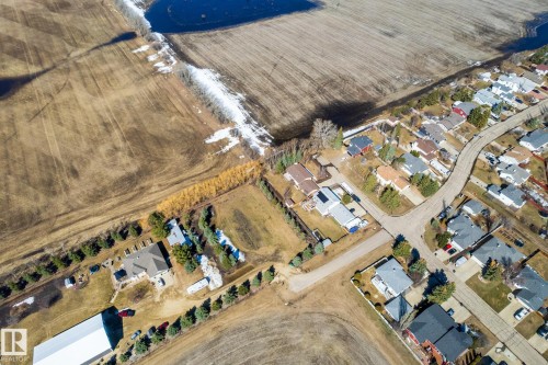 Aerial perspective showcasing residential properties bordering agricultural fields - 2B Discovery Avenue, Rural Sturgeon County, AB 
