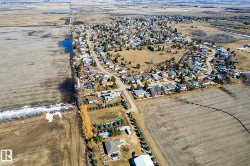 Aerial perspective of a residential area surrounded by agricultural land - 2B Discovery Avenue, Rural Sturgeon County, AB 