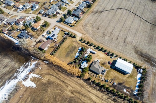Aerial perspective showcasing a property featuring a single-family residence, a large outbuilding, and mature perimeter trees - 2B Discovery Avenue, Rural Sturgeon County, AB 