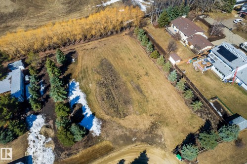 Expansive land parcel featuring mature evergreen trees and a variety of deciduous trees along the perimeter - 2B Discovery Avenue, Rural Sturgeon County, AB 