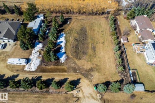 Expansive land parcel featuring mature evergreen trees and partially cleared terrain - 2B Discovery Avenue, Rural Sturgeon County, AB 