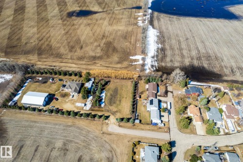 Expansive property featuring a large residential structure, a substantial outbuilding, and mature perimeter trees - 2B Discovery Avenue, Rural Sturgeon County, AB 