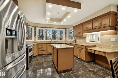 Kitchen featuring stainless steel appliances, a central island with countertop, extensive cabinetry, and recessed ceiling lighting - 33 Glen Meadow Crescent, St. Albert, AB - Indoor Photo Showing Kitchen