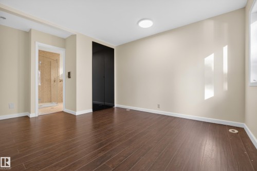 Spacious room featuring wood-finish flooring, light-colored walls, and a recessed ceiling light - 33 Glen Meadow Crescent, St. Albert, AB - Indoor Photo Showing Other Room