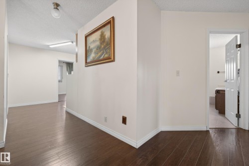 Hallway featuring wood-finish flooring, white baseboards, and neutral wall tones - 33 Glen Meadow Crescent, St. Albert, AB - Indoor Photo Showing Other Room