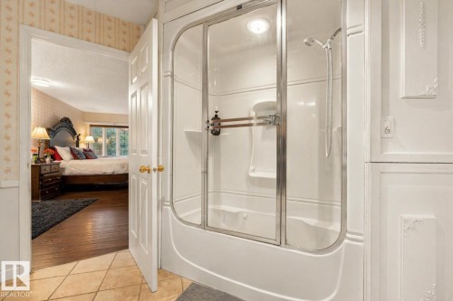 Bathroom featuring a white shower-tub combination with glass enclosure - 33 Glen Meadow Crescent, St. Albert, AB - Indoor Photo Showing Bathroom