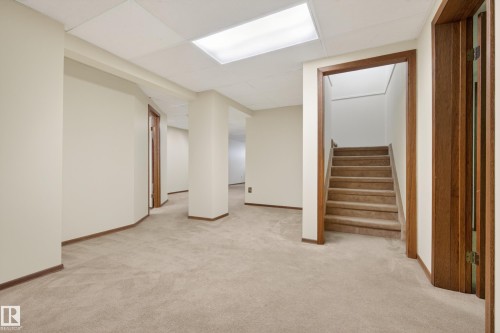 Versatile lower level with neutral carpet flooring and light beige walls - 33 Glen Meadow Crescent, St. Albert, AB - Indoor Photo Showing Other Room
