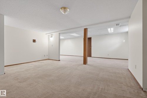 Expansive carpeted area with white walls and a drop ceiling - 33 Glen Meadow Crescent, St. Albert, AB - Indoor Photo Showing Other Room