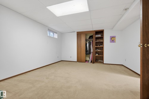 Carpeted interior space featuring white walls and a drop ceiling with recessed lighting - 33 Glen Meadow Crescent, St. Albert, AB - Indoor