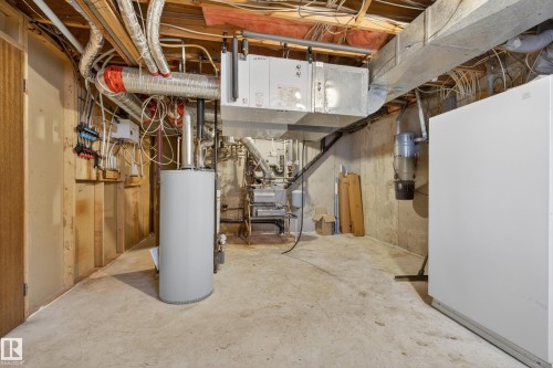 Utility room featuring a water heater, furnace system, exposed ductwork, and concrete flooring - 33 Glen Meadow Crescent, St. Albert, AB - Indoor Photo Showing Basement