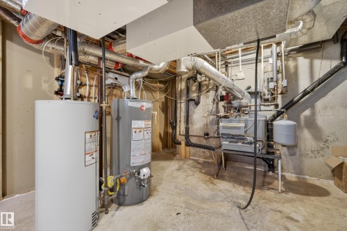 Utility area featuring two water heaters, extensive ductwork, and a furnace unit - 33 Glen Meadow Crescent, St. Albert, AB - Indoor Photo Showing Basement