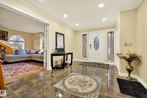Grand entryway featuring polished floor tiles with an intricate mosaic inlay, a white front door with an oval glass insert, and recessed lighting - 33 Glen Meadow Crescent, St. Albert, AB - Indoor Photo Showing Other Room