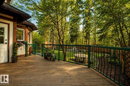 Spacious wood-finish deck featuring a green metal railing, offering expansive outdoor living - 33 Glen Meadow Crescent, St. Albert, AB - Outdoor With Deck Patio Veranda With Exterior