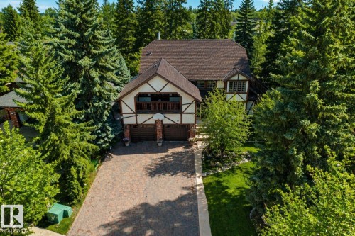 Tudor-style exterior with a prominent brown shingle roof and white stucco siding - 33 Glen Meadow Crescent, St. Albert, AB - Outdoor
