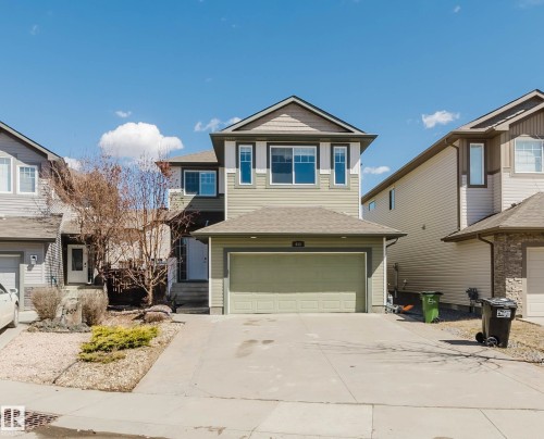 Two-story property featuring a front-facing attached garage and a concrete driveway - 611 176 Street, Edmonton, AB - Outdoor With Facade