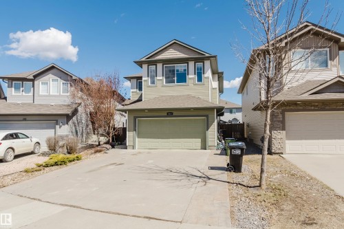 Two-story home with a two-car attached garage, light green siding, and contrasting trim - 611 176 Street, Edmonton, AB - Outdoor With Facade