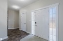 Entryway featuring a white paneled door with frosted sidelight windows, durable wood-finish flooring, and a flush-mount ceiling light - 611 176 Street, Edmonton, AB  - Indoor Photo Showing Other Room 