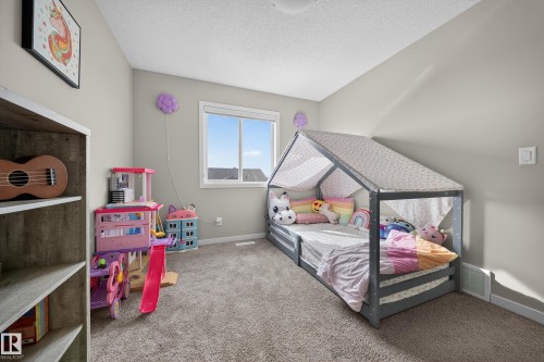 This room features a window providing natural light, light-colored walls, and carpeting - 2118 52A Street, Edmonton, AB - Indoor Photo Showing Bedroom