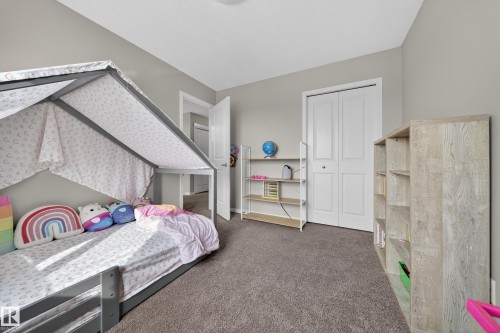 This room features plush carpeting and light grey walls, creating a neutral and inviting atmosphere - 2118 52A Street, Edmonton, AB - Indoor Photo Showing Bedroom