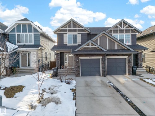 This property features a two-story exterior with a two-car garage and a paved driveway - 2118 52A Street, Edmonton, AB - Outdoor With Facade