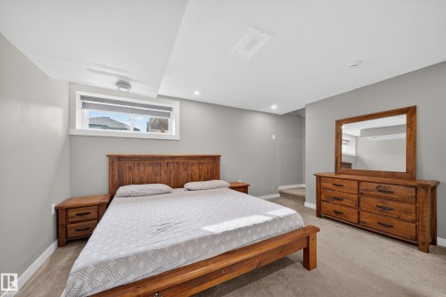 The bedroom features light gray walls, a window with a roller shade, recessed lighting, and carpeting - 2118 52A Street, Edmonton, AB - Indoor Photo Showing Bedroom