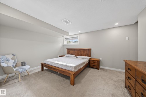 This room features neutral-toned walls, recessed lighting, and a window providing natural light - 2118 52A Street, Edmonton, AB - Indoor Photo Showing Bedroom