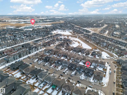 Aerial view showcasing the residential neighbourhood, with visible houses, roads, and open land areas - 2118 52A Street, Edmonton, AB - Outdoor With View