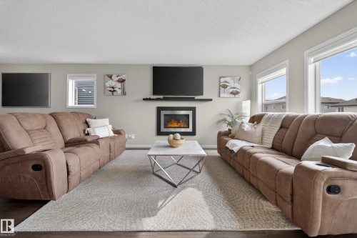 Living room featuring light grey walls, recessed lighting, and dark wood flooring - 2118 52A Street, Edmonton, AB - Indoor Photo Showing Living Room With Fireplace